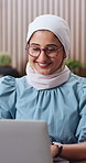 Laptop, reading and muslim woman in office with smile, creativity and good news for digital marketing. Happy, Islamic person and glasses in workplace with computer, advertising project and research.