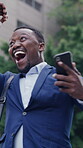 Celebration, fist pump and phone with business black man in city for reaction to good news or success. App, laughing ad text message with excited African employee outdoor for alert or notification