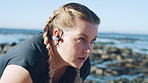 Breathing, earphones and fitness with woman on beach for recovery or rest from training fatigue, Exercise, thinking and tired with exhausted person outdoor for health, cardio workout or wellness