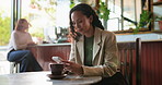 Cellphone, laptop and woman in cafe with texting, social media or typing email on mobile app. Technology, notification and female person with computer and phone for chatting on website in coffee shop