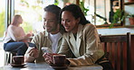 Online shopping, couple and hug with phone in coffee shop for purchase, vacation booking or web research. Happy people, credit card and tech in cafe for holiday service, bonding together or ecommerce