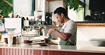 Barista, man and milk with coffee in cafe for customer service, beverage preparation or hospitality. Worker, caffeine or pour dairy with cream for drink, make latte or process order in small business