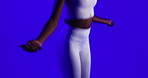 Fitness, hands and jump rope in studio for training, exercise and cardio on blue background. Workout, skipping or woman with equipment for endurance, sports and agile with energy for wellness