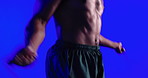 Hands, skipping and rope for exercise in studio with jumping, balance or intense training on blue background. Person, gear and shirtless for fitness, cardio challenge and workout for wellness at gym