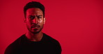 Tired, face and man with training, breathing and cardio workout on red studio background. Sweating, fatigue or healthy person with fitness, rest and cool down and introspection for exercise goals