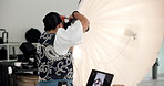Woman, photographer and flash of camera in studio for production, photoshoot and catalog. Female person, backstage and equipment for photography results, filming and videography for content creation
