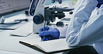 Scientist, woman and microscope with writing in lab for clinical trial, medical results or innovation. Biotech, mature person or equipment with notes for cancer research, vaccine development or study