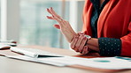 Woman, hands or typing with wrist pain in office for strain, overworked or pressure on desk. Female person, employee or sore arm on keyboard for carpal tunnel syndrome, joint injury or muscle tension