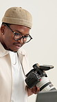 Black man, laptop and camera in studio for photography, project management or review at media company. Person, photographer and smile with computer, editing or production process at creative agency