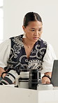 Woman, laptop and camera in workshop for photography, project management and review at media company. Person, photographer and gear with computer, editing or production process at creative agency