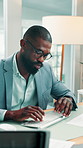 Paperwork, reading or black man typing in office, identify new market trend or forecasting proposal. Data analysis, review or finance analyst with economy status report, risk assessment or projection