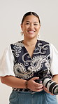 Happy woman, face and photographer with camera in studio for photoshoot or production service. Portrait, female person or videographer with smile for digital creativity or art on a white background