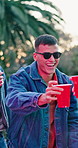 Man, toast and beer at party with friends, drinks and reunion in backyard for event or youth culture. Home, vacation and people in group celebration with alcohol, cheers or smile for social gathering