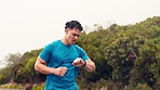 Fitness, man and running with smart watch outdoor for pace timer, endurance and track performance. Mist, athlete and check stopwatch in nature for workout app, exercise challenge and cardio progress