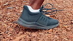 Person, runner and stones with shoe for sprint, race or outdoor training on dirt trail or path. Closeup, sprinter and challenge with sneaker for extreme sport, fitness workout or cardio exercise