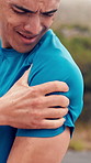 Man, fitness and arm with injury in nature for workout accident, strain or muscle tension. Active, male person or runner with sore shoulder or ache for joint inflammation, outdoor exercise or sprain