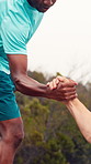 Nature, help and men on mountain for exercise, hiking and trekking for health, wellness and adventure. Athlete, friends and people with support for workout, fitness and training together outdoor