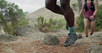 Shoes, hiking and people with fitness, explore for adventure and trekking for health benefits. Nature, hiker and friends with sneakers, legs or exercise for wellness, stone path or vacation for break