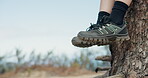 Break, feet and hiking with person outdoor in nature for adventure, fitness or sports hobby. Blue sky space, relax and sneakers with hiker in forest for journey, rest or scenic view of environment