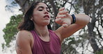 Below, watch and wind with woman in nature for adventure, hiking hobby or running fatigue. Breathing, fitness and time with hiker person outdoor in mountain for exercise, rest or tracking progress