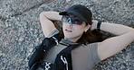 Breathing, hiking and rest with woman on rock in nature for fitness, recovery or wellness activity. Above, hands behind head and sunglasses with hiker person outdoor for adventure, break or chilling