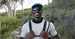 Fitness, face or hiker in nature with gear, pride or progress in outdoor workout. Happy, portrait and black man in woods with sportswear, trekking exercise or training confidence in body improvement.