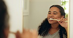 Brushing teeth, mirror and woman in bathroom, dental hygiene and morning routine for self care. Oral health, reflection and person in home, toothpaste and cleaning mouth for wellness or remove plaque
