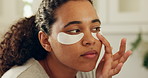 Skincare, application and woman with patches in bathroom, reduce dark circles and hydration treatment. Under eye glow, self care or person with collagen mask for grooming routine, home or dermatology