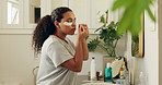 Skincare, apply and woman with patches in bathroom, dark circles reduction and hydration beauty treatment. Mirror, self care and person with collagen product for dermatology routine, home or eye mask