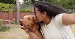 Kiss, woman and selfie with dog in backyard for adoption memory, status update or bonding together. Hug, african person and photo with animal in home garden for profile picture, affection and loyalty