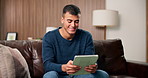 Home, relax and man on sofa, tablet for social media and digital app for entertainment. Apartment, tech and happy person on couch, connection and internet for texting, subscription and online reading