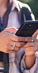 Hands, hiking and woman in forest, smartphone for direction and digital app for journey update. Closeup, person and hiker in woods, typing and cellphone for maps, internet and social media for travel