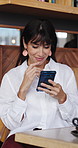 Smile, smartphone and woman in cafe, typing and digital app for social media, texting and internet. Customer, mobile user and mature person in coffee shop, network and cellphone for communication