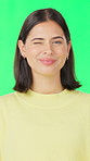 Face, laughing and wink with woman on green screen for comedy, humor or reaction to joke. Excited, flirting and funny with happy person isolated on studio for cheerful satisfaction or wellness