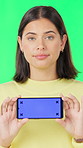Woman, face and phone with green screen in studio with ui display, choice or shaking head for no. Person, answer and smartphone in portrait with app ux, decision and mockup space with promo in Spain