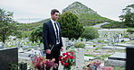 Mourning, graveyard and man by tombstone for loss, death and grief at funeral or memorial service. Ceremony, religious ritual and person with bible in cemetery for goodbye, memory and farewell