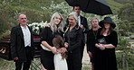 Sad, people and hug child at graveyard for funeral ceremony, burial service and mourning loss. Family, embrace and kid with depression, emotional breakdown and tribute gathering at farewell memorial 