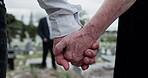 Cemetery, people and holding hands for memorial service, family mourning and compassion for comfort. Sympathy, care and senior woman with son for emotional support, loss and grieving at graveyard