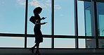 Business woman, phone and texting in hallway by window, walk and notification at real estate company. Person, smartphone and realtor in corridor with mobile app, contact or social media at agency