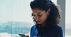 Woman, phone and texting in office by window, space and check notification at insurance company. Person, smartphone and broker on mobile app, contact and smile for feedback at risk assessment agency