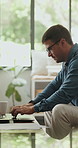Typing, laptop and man in living room for hybrid work, review budget or accounting with audit report. Computer, home and freelance accountant in house for financial proposal, taxes or bookkeeping