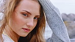 Beach, face and woman on holiday in nature, wind and relax on peaceful getaway or traveler on break. Outdoor, travel and person on vacation for adventure, tourist and tourism at sea on weekend in USA
