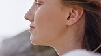 Beach vacation, mindfulness and woman in nature, wind and relax with smile on getaway and adventure. Breathing, tourist and person with thoughts on holiday, calm and reflection on weekend or peace