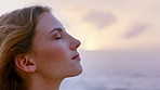 Wind, thinking and woman with peace at beach, remember memory and mindfulness for holiday reflection. Sunset, summer break or calm person with sea breeze for vacation mindset, daydream or perspective
