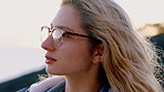 Glasses, hiking and windy with woman outdoor for calm breathing, fresh air or travel hobby. Adventure, peace and sightseeing with hiker person in nature for explore, health or wellness activity