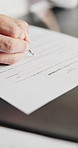 Person, hands or writing with contract for agreement, hiring or recruitment process on desk. Closeup, employee or filling form with pen or signature for legal compliance, policy or insurance on table
