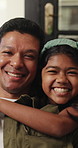 Happy, hug and face of child with dad on sofa for connection, relationship and bonding on weekend. Home, family and portrait of father with girl in embrace for affection, support and trust together