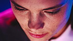 Neon, face and woman streaming with closeup, subscription service and entertainment at night in home. Film, person and watch movie, online show and drama series on internet on weekend in apartment