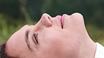 Woman, happy and relax with laying at park for thinking, reflection and break in nature with memory. Girl, rest and happy with breathing, perspective and outdoor with profile on ground for daydream