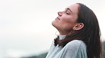 Woman, relax and breathing outdoor with smile, mindfulness and thinking for inspiration on vacation. Space, female person and zen reflection with fresh air, wellness and peace for tranquil holiday.